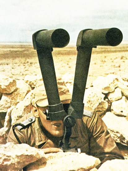 A German soldier in the Western Desert in 1942 scans the horizon for enemy movements