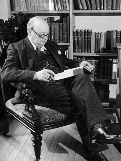 Churchill reading in his library at Chartwell