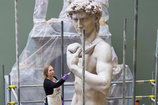 Conservator Johanna Puisto dusts the cast of Michelangelo’s ‘David’ post-conservation, November 2014