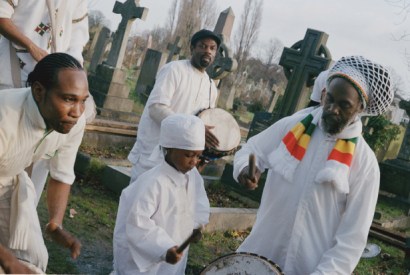 Drummers at a graveside wear white, based on Ethiopian orthodox funeral traditions