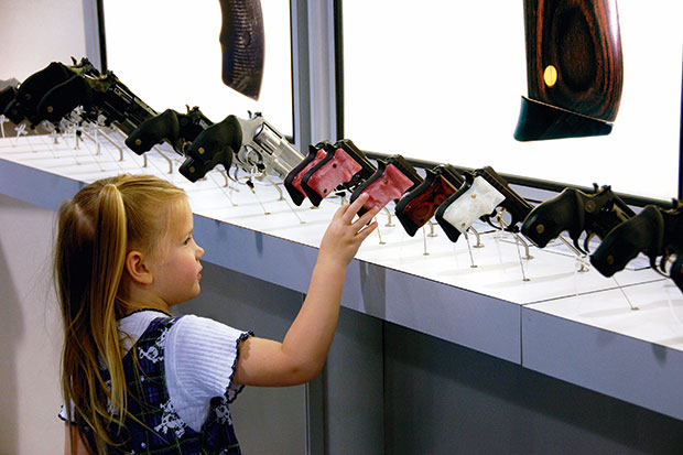 Fatal attraction: a four-year-old picks her favourite handgun at the NRA’s annual meeting in Milwaukee, 2006