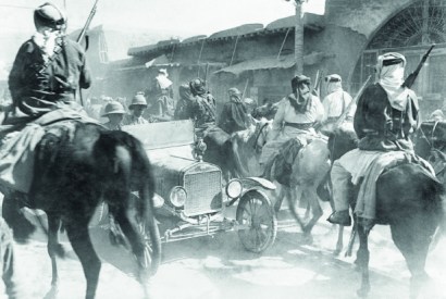 British officers in a modern motor car drive against the current of horsemen of the Arab army entering Damascus on 1 October 1918. Anglo-Arab policies were equally at cross purposes following the fall of the city