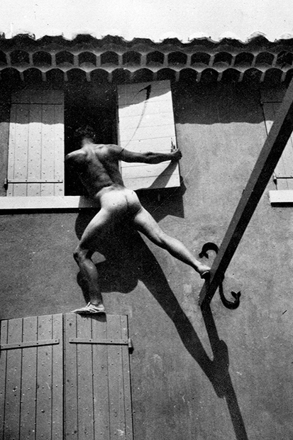 Bunny Garnett climbing into a window at La Bergère, Cassis, in the 1920s
