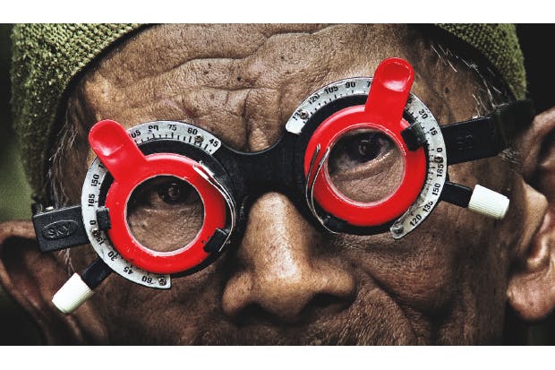 Adi Rukun tests the eyes of one of the men who killed his brother