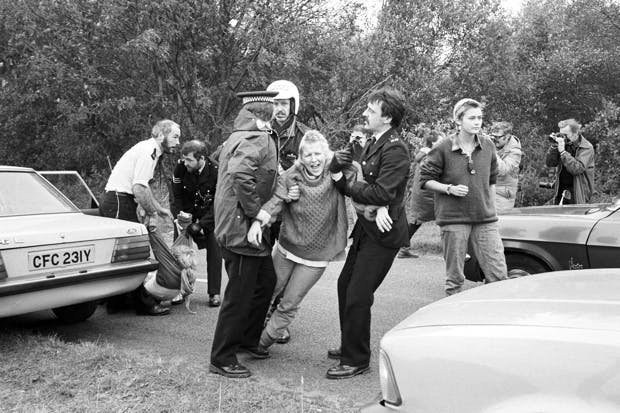 A demonstrator is arrested during an anti-nuclear protest at Greenham Common air base in 1983. (Photo: D. Jones/Express/Getty)