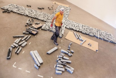 Richard Long installing the large slate cross, Time and Space (2015), at the Arnolfini
