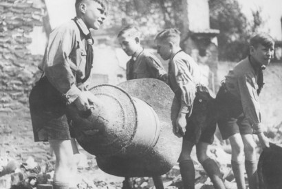 Members of the Hitler Youth clear debris after an air raid on Berlin, August 1944