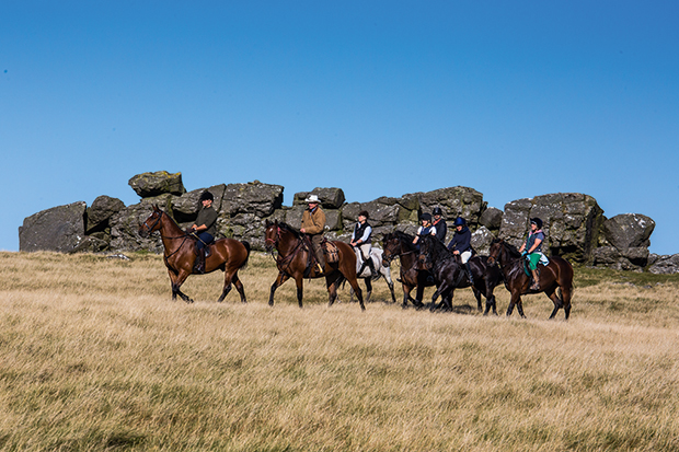 Stetson-clad Phil Heard leads riders on the moor