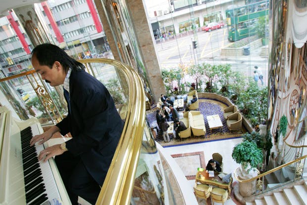 A musician plays in the lobby of the Regal hotel in Hong Kong. Photo: Lucas Schifres/Bloomberg/Getty Images