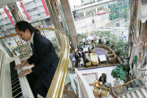 A musician plays in the lobby of the Regal hotel in Hong Kong. Photo: Lucas Schifres/Bloomberg/Getty Images