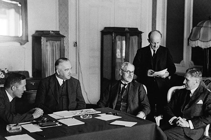 The brisk, implacable Sir Maurice Hankey (second from right) stands between Ramsay Macdonald and Franz von Papen at the Reparations Conference in Lausanne in 1932