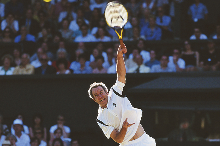 McEnroe serving in a mixed doubles match with Steffi Graf at Wimbledon, 1999