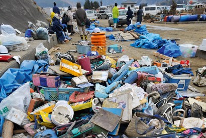 A pile of mud-covered satchels is all that remains of 74 children’s lives