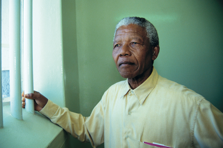 Mandela revisits his prison cell on Robben Island in 1994 [Getty]