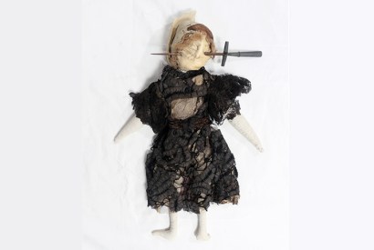 Stuffed doll in Edwardian-style black dress with stiletto through face, south Devon, England , 1909–13