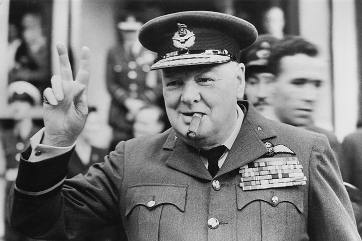 Giving the famous V-sign at the opening of RAAF headquarters, Croydon, 1948 [Getty]