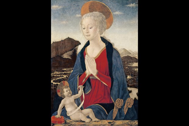 Alesso Baldovinetti’s ‘Madonna and Child’ (c. 1464) is rich in symbolism. The infant Christ holds his swaddling band up to the Virgin’s womb, as if it were a token of the umbilical cord that united them. The winding shape of the bandage is echoed in the distant meandering river. The Madonna’s gossamer veil falls over her head as a pyx-cloth might cover a sacramental vessel.The child touches another translucent veil, draped over the cushion beside him. Towering above him, his Mother joins her hands in devotion, as if to acknowledge her Son’s meaningful gestures