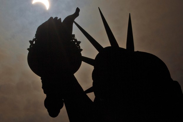 The Statue of Liberty, photographed during a partial solar eclipse. ‘Far from being a cheerful present from one nation to another, Liberty is a subversive and occult statement’