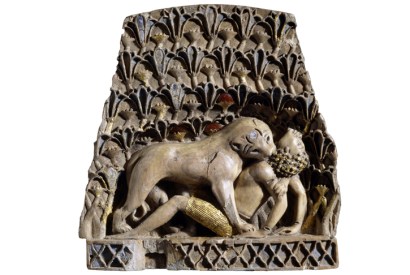 Ivory plaque of a lioness mauling a man, ivory, gold, cornelian, lapis lazuli, Nimrud, 900 BC–700 BC. [© The Trustees of the British Museum]