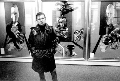 Francis Bacon in front of his triptych at the Galerie Claude Bernard in the Rue des Beaux Arts, Paris in 1977