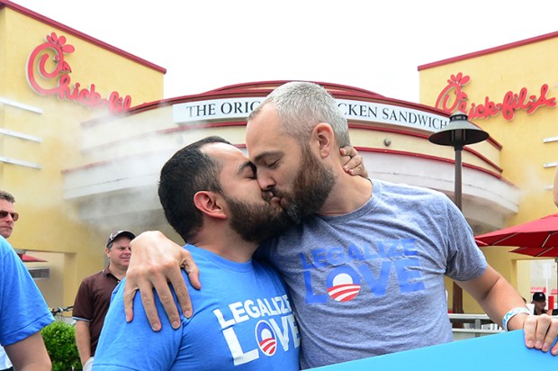 A couple stage a ‘kiss-in’ in front of a Chick-fil-A in Hollywood in protest at the fast-food chain’s opposition to same-sex marriage [Frederic J. Brown/AFP/Getty Images]