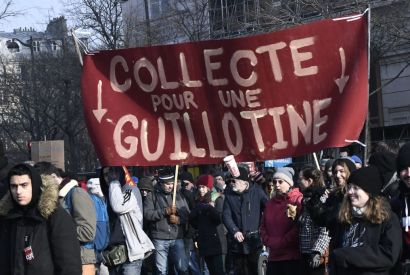 Protesters hold a banner reading ''Fund-raising for a guillotine'