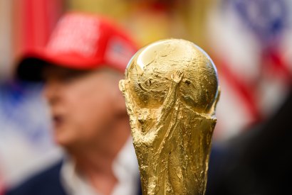 The soccer World Cup trophy sits in front of President Donald Trump