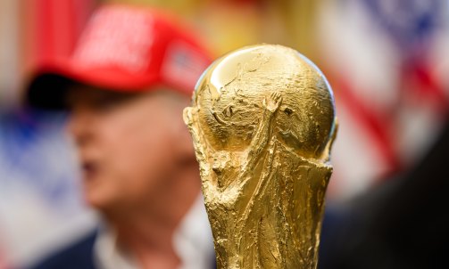 The soccer World Cup trophy sits in front of President Donald Trump