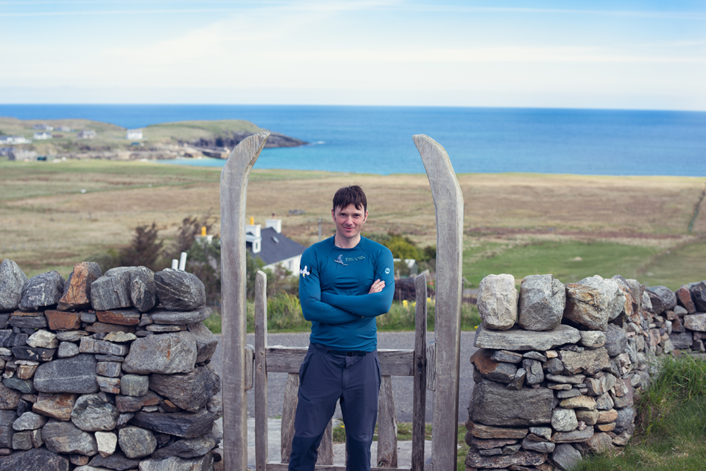 Alone on a vast fjord, surrounded by whales, beneath the midnight sun